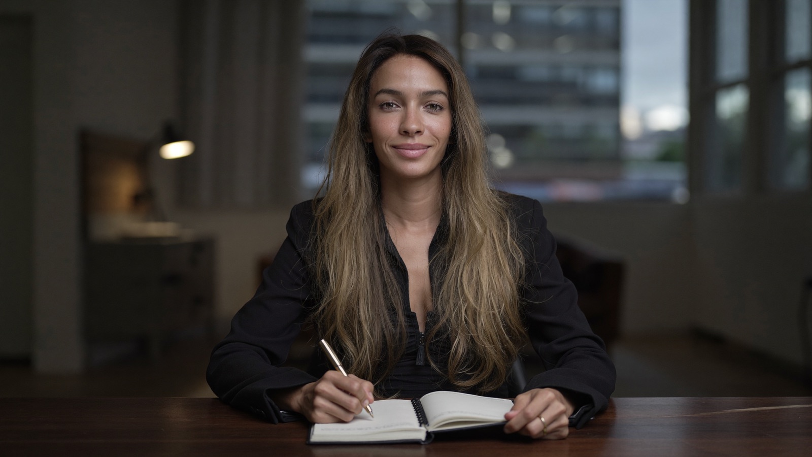 Geisa reviewing a client system at her desk